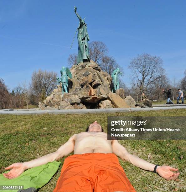 Casey Ambrose, of Albany, tries to get a jump start on his tan in Washington Park in Albany, NY on March 17, 2011.