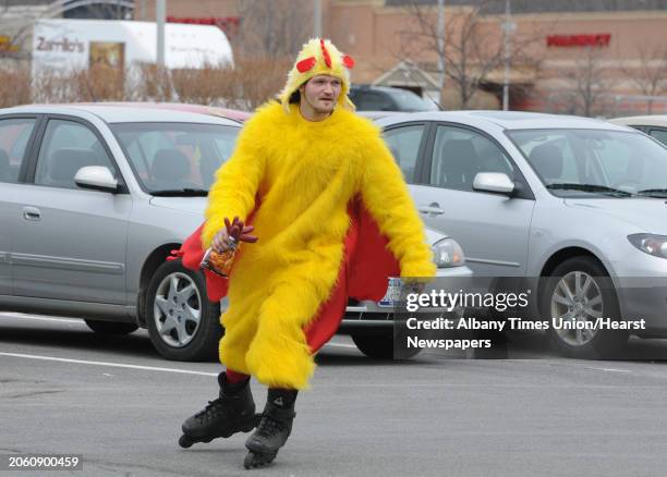 Adam "Spicey" Gibbs of Schenectady rollarblades around the parking lot of Mohawk Commons dressed in a chicken suit in Schenectady N.Y. On Friday...