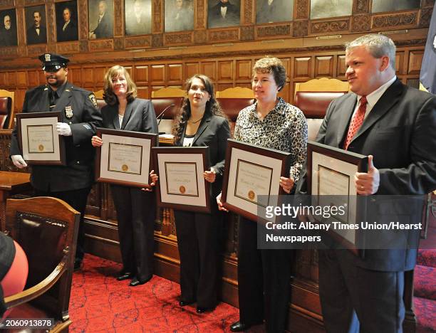 The recipients for the 2011 Merit Performance Award, the highest honor bestowed upon employees of the New York State court system, stand with their...