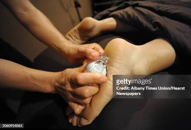 Times Union reporter Paul Grondahl gets a Golf Ball Massage from massage therapist Lindsay Harvey at Complexions Spa in Colonie, N.Y. On Wednesday,...