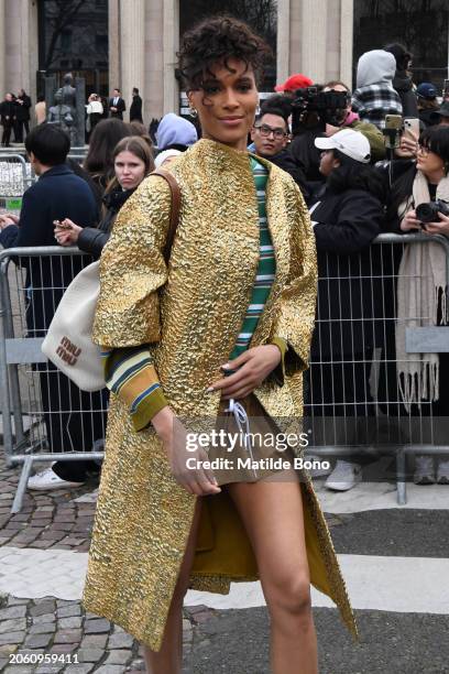 Cindy Bruna is seen wearing a white Miu Miu bag, a golden Miu Miu coat, a green with white stripes Miu Miu shirt and brown Miu Miu skirt outside the...