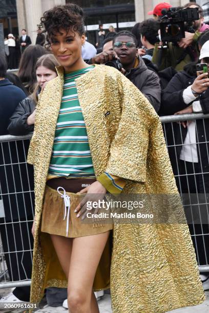 Cindy Bruna is seen wearing a golden Miu Miu coat, a green with white stripes Miu Miu shirt, brown Miu Miu skirt and brown Miu Miu underwear outside...