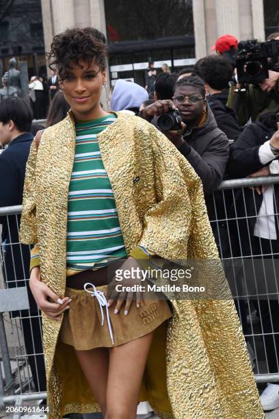 Cindy Bruna is seen wearing a golden Miu Miu coat, a green with white stripes Miu Miu shirt, brown Miu Miu skirt and brown Miu Miu underwear outside...