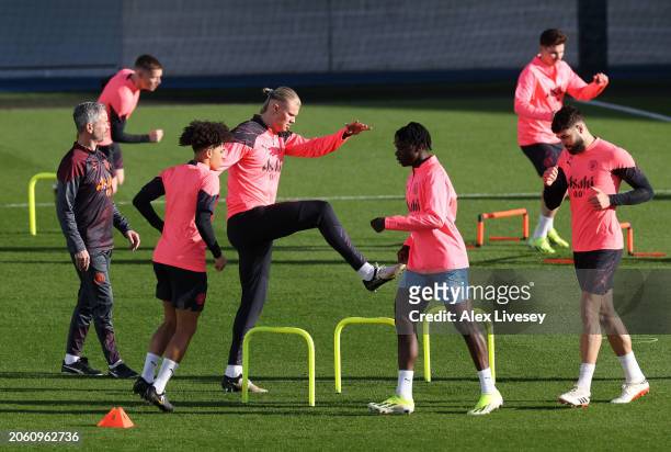 Erling Haaland of Manchester City warms up during a training session at Manchester City Football Academy on March 05, 2024 in Manchester, England.