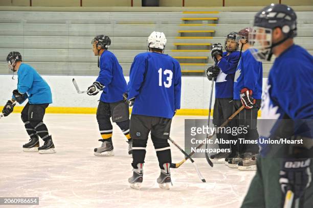 Men warm up before an adult men's hockey league game at Albany County Hockey Rink in Albany, N.Y. Wednesday, Oct. 5, 2011.