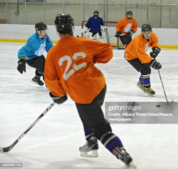 Men play in an adult men's hockey league game at Albany County Hockey Rink in Albany, N.Y. Wednesday, Oct. 5, 2011.