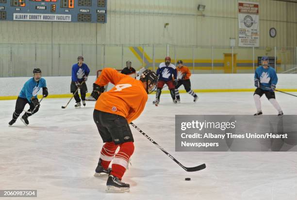 Men play in an adult men's hockey league game at Albany County Hockey Rink in Albany, N.Y. Wednesday, Oct. 5, 2011.