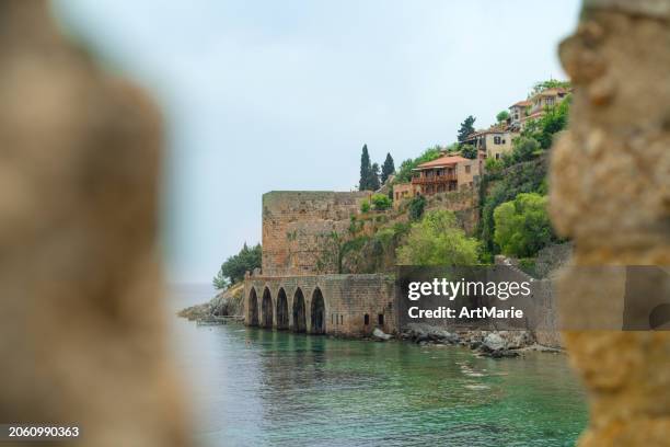 ancient shipyard and old town district of  alanya, turkey - alanya castle stock pictures, royalty-free photos & images