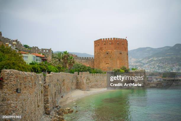 kizil kule (red tower) in alanya, turkey, part of old castle, sea and harbor - alanya castle stock pictures, royalty-free photos & images