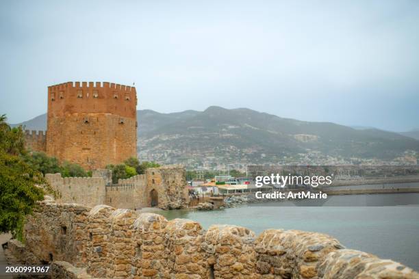 kizil kule (red tower) in alanya, turkey, part of old castle, sea and harbor - alanya castle stock pictures, royalty-free photos & images