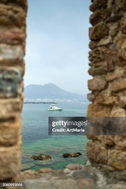 view to the sea and sailing ship through old walls of alanya fortress, turkey - alanya castle stock pictures, royalty-free photos & images