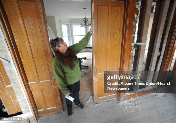 Barb Monsees tries to move a sliding wood door which is still stuck from debris in her home in Schoharie, N.Y. Friday, Nov. 18, 2011. Barb's house...