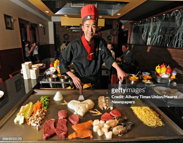 Teppanyaki chef Jason Lee stands with food on the teppanyaki grill at Sake Japanese Steakhouse on Tuesday, Nov. 29, 2011 in Latham, N.Y.