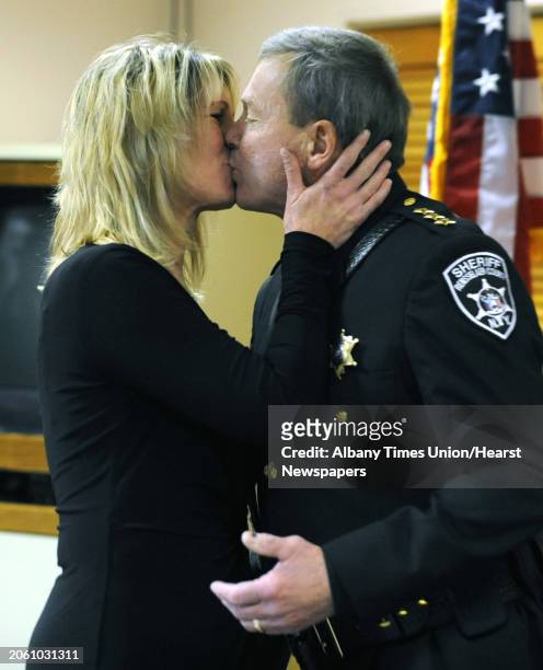 Sheriff Jack Mahar gets a kiss from his wife Selina after being sworn in for a third term by Hon. Michael Melkonian on Monday, Jan. 2, 2012 at the...