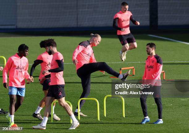 Erling Haaland of Manchester City warms up during a training session at Manchester City Football Academy on March 05, 2024 in Manchester, England.