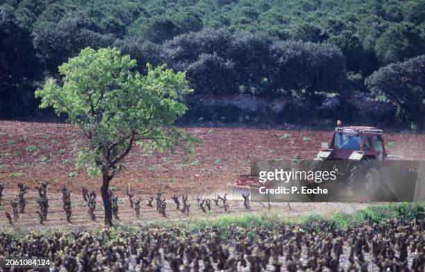 tractor plowing a field - agriculteur blé stock-fotos und bilder