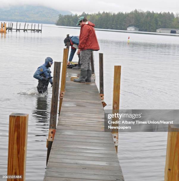 Co-Executive Director for the Lake Champlain Maritime Museum Adam Kane gets out of the water after looking for Asian clams Thursday, May 3, 2012 at...