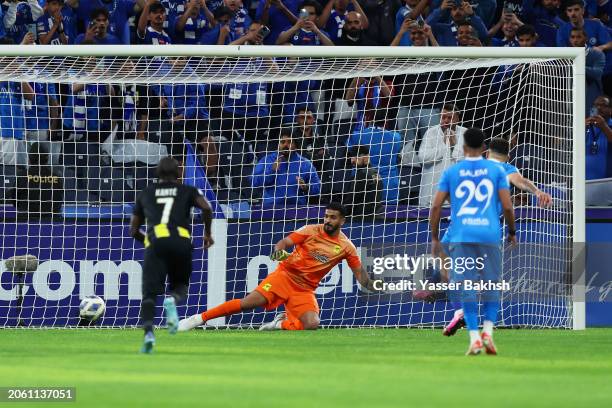 Abdullah Al-Mayouf of Al Ittihad fails to save a penalty kick from Aleksandar Mitrovic of Al Hilal , resulting in Al Hilal's first goal during the...