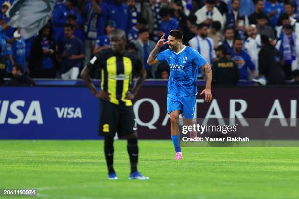 Aleksandar Mitrovic of Al Hilal celebrates scoring his team's first goal from a penalty kick as N'Golo Kante of Al Ittihad looks dejected during the...