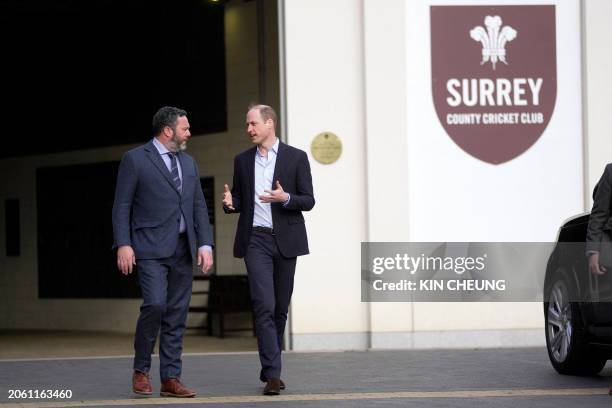 Britain's Prince William, Prince of Wales chats with Surrey CCC chairman Oli Slipper while leaving the Kia Oval cricket ground after meeting with...