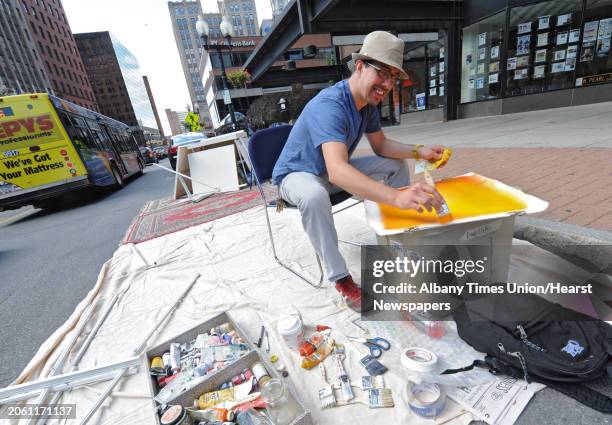 Tony Iadicicco of Albany paints an abstract piece of art on North Pearl street on PARK Day Friday, Sept. 21, 2012 in Albany, N.Y. PARK Day is an...