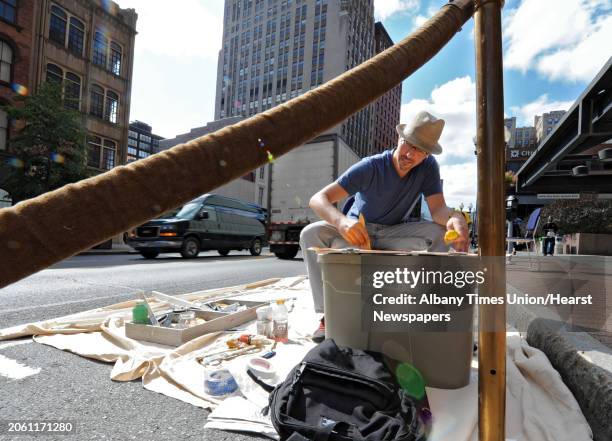 Tony Iadicicco of Albany paints an abstract piece of art on North Pearl street on PARK Day Friday, Sept. 21, 2012 in Albany, N.Y. PARK Day is an...