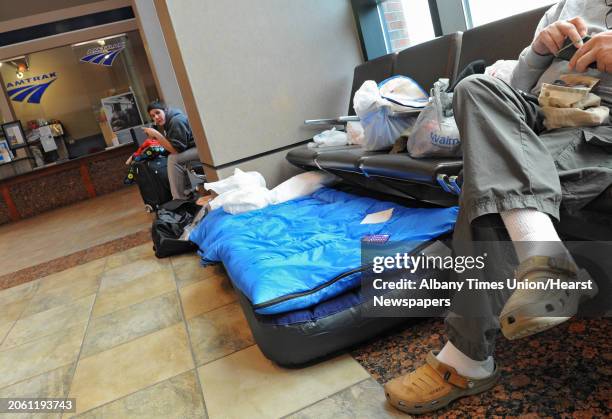 Couple of stranded passengers wait at the Albany-Rensselaer Train Station on Tuesday, Oct. 30, 2012 in Rensselaer, N.Y. Hurricane Sandy caused...