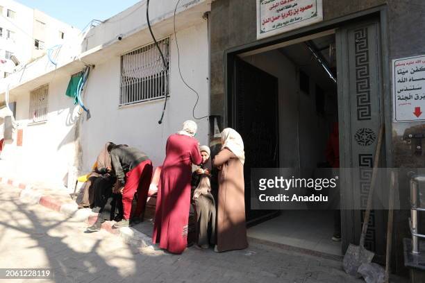Relatives mourn as the deceased Palestinians are brought to the morgue at Shifa Hospital after it was reported that there were deaths and injuries as...