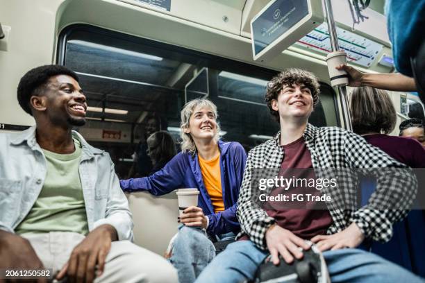 friends talking in railroad car - public transportation stock pictures, royalty-free photos & images