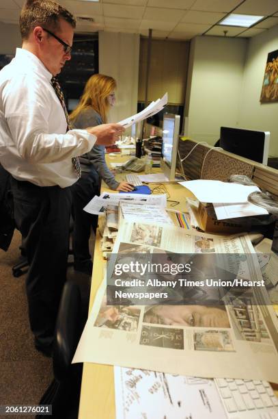 Daniel Roberts and Patti Shunk work on pages in the newsroom the night of the first official press run on the new KBA press at the Times Union on...