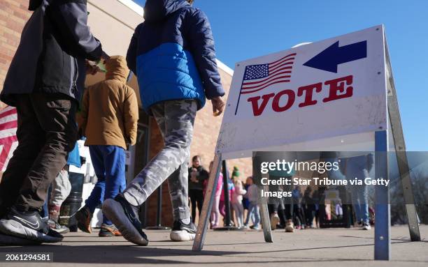 Students line up as voters walk into the polling place to cast their ballots for the Presidential primary election, Tuesday, March 5, 2024 at...