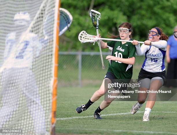 Shenendehowa's Maddie Shea, left, is defended by Shaker's Maddy Smith as she tries to score during a Section II Class A girls' lacrosse semifinal on...