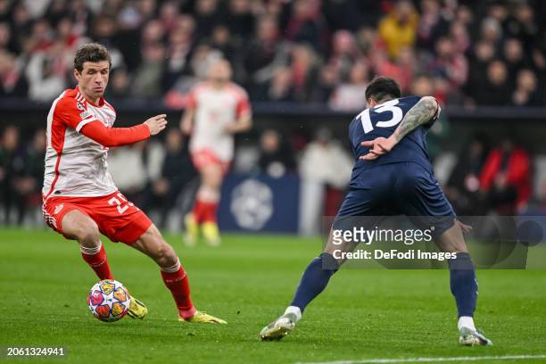 Thomas Mueller of Bayern Muenchen and Alessio Romagnoli of SS Lazio battle for the ball during the UEFA Champions League 2023/24 round of 16 second...