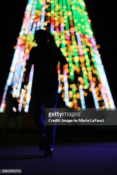 abstract holiday lights with human silhouette - celebration fl stock pictures, royalty-free photos & images