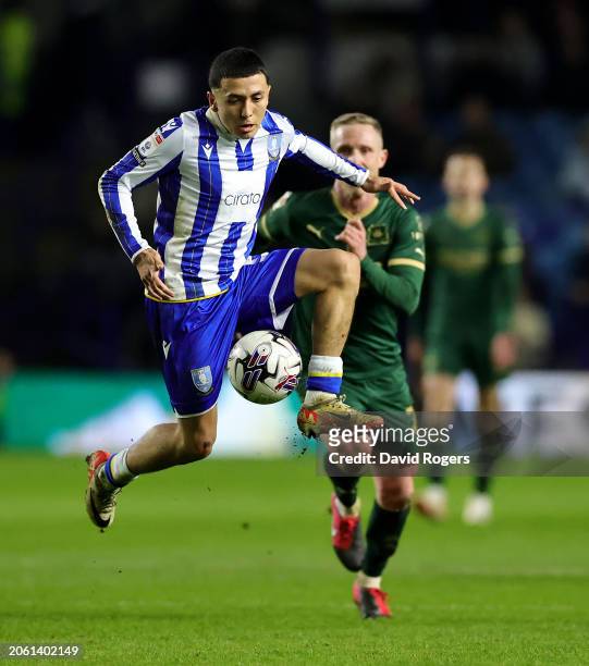 Ian Poveda of Sheffield Wednesday controls the ball watched by Adam Forshaw during the Sky Bet Championship match between Sheffield Wednesday and...