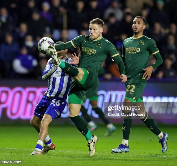 Lewis Gibson of Plymouth Argyle clears from Ian Poveda during the Sky Bet Championship match between Sheffield Wednesday and Plymouth Argyle at...