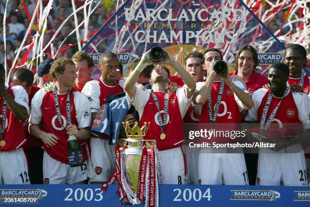 May 15: Ray Parlor, Theirry Henry, Freddie Ljungberg and Edu of Arsenal celebrate with Premiership trophy after the Premier League match between...