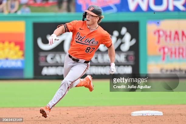 Jackson Holliday of the Baltimore Orioles rounds second base after hitting a triple in the third inning against the Philadelphia Phillies during a...