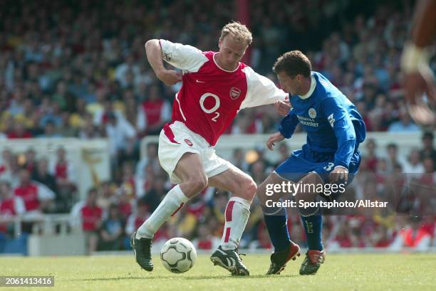 May 15: Dennis Bergkamp of Arsenal and Billy Mckinlay of Leicester challenge during the Premier League match between Arsenal and Leicester at...