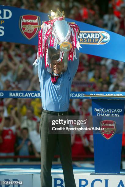 May 15: Arsene Wenger of Arsenal celebrates with the Premier League Trophy after becoming a 2003-2004 Premiership champion after the Premier League...
