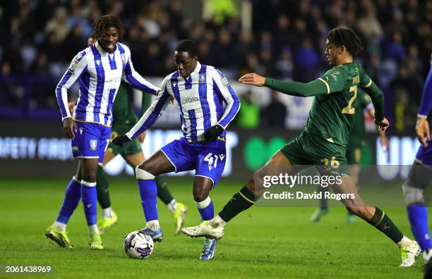 Djeidi Gassama of Sheffield Wednesday is tackled by Ashley Phillips during the Sky Bet Championship match between Sheffield Wednesday and Plymouth...