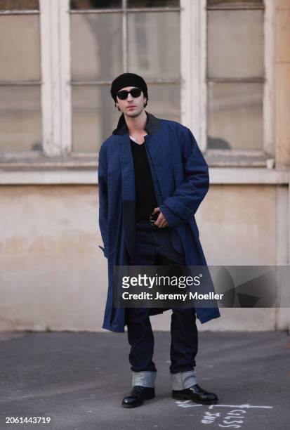 Alexander Roth seen wearing black Ray Ben sunglasses, blue long coat, black shirt, dark blue pants, black hat and black shoes outside Sacai show...