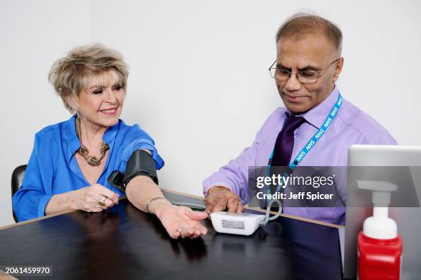 In this image released on March 11 Gloria Hunniford gets their blood pressure checked by pharmacist Deepak to encourage people to get their blood...