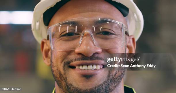 man, face and safety goggles with engineer in workshop, construction or maintenance with smile. employee happy in portrait, engineering and glasses for protection in factory with labor and helmet - handyman smiling imagens e fotografias de stock