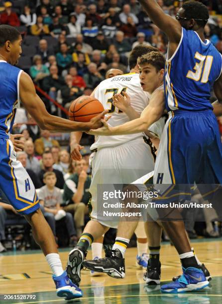 Siena's Rob Poole squeezes between a couple of players trying to get to the ball during a basketball game against Hofstra at the Times Union Center...