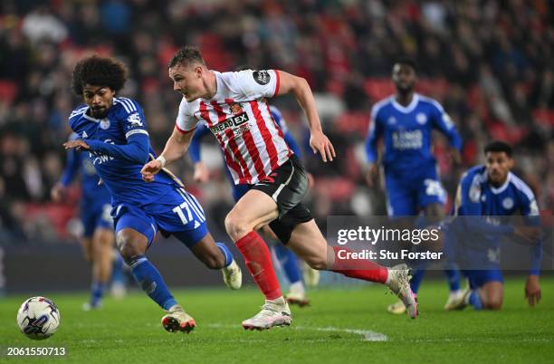 Sunderland player Dan Ballard chases down the ball in the penalty area before being challenged by Leicester player Hamza Choudhury during the Sky Bet...