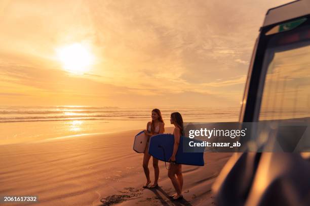 friends with buggy board heading to beach. - adventure stock pictures, royalty-free photos & images
