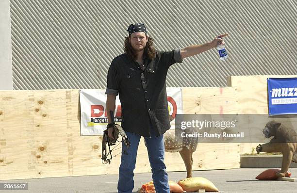 Singer Blake Shelton prepares to compete in the Andy Griggs Celebrity Archery tournament during the 32nd annual FanFair country music festival June...