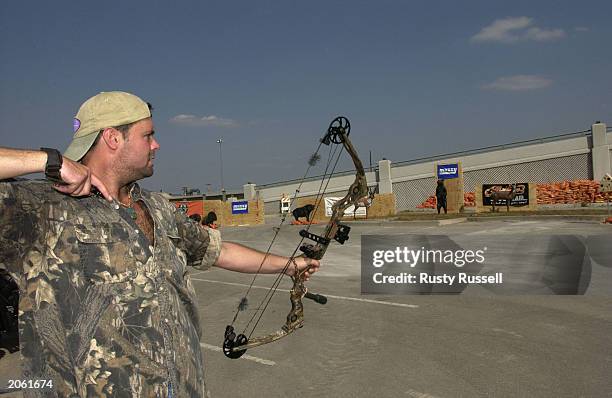 Singer Troy Gentry of the country music duo Montgomery Gentry prepares to compete in the Andy Griggs Celebrity Archery tournament during the 32nd...