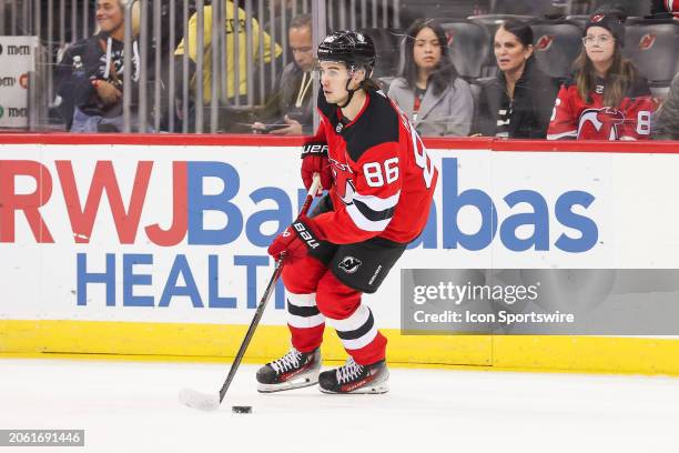 New Jersey Devils center Jack Hughes skates with the puck during a game between the St. Louis Blues and New Jersey Devils on March 7, 2024 at...